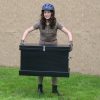 young lady holding a black starter trunk